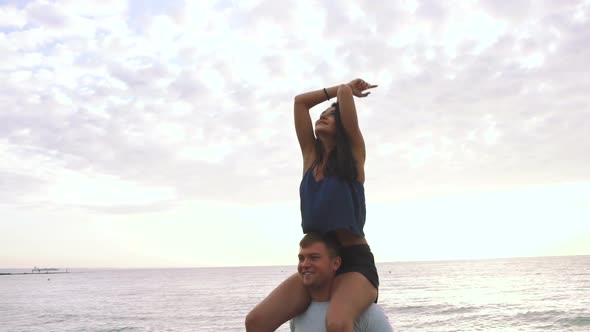 Happy Young Couple Having Some Fun on the Beach During Sunset Slow Motion
