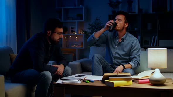 Two Young Men Work at Home at Night