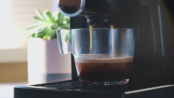 Coffee Machine Making Espresso in Glass Transparent Coffee Cup