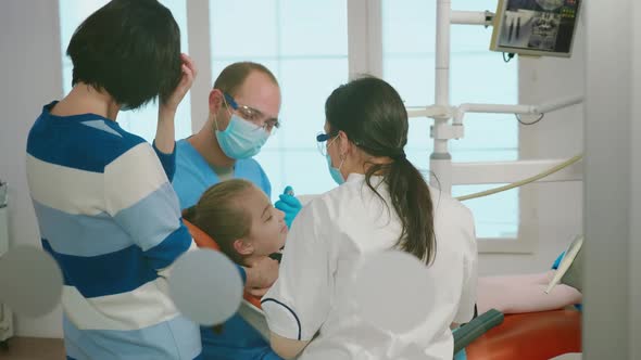 Stomatologist Doctors Treating Dental Problems of Child