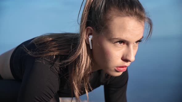 Closeup Woman Jogger Preparing to Running From Low Start at Beach