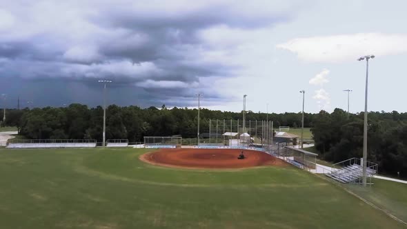 Arial view preparation of ballpark man riding rake equipment