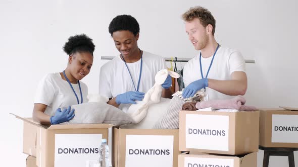 Diverse Charity Volunteers Sorting Through Donated Goods