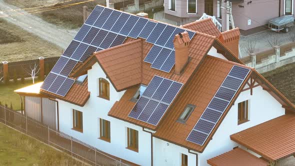 Residential House with Rooftop Covered with Solar Photovoltaic Panels for Producing of Clean