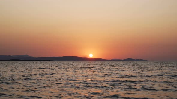 Golden Calm Waves Moving with Magical Red Sunset in the Background