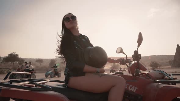 Cute Brunette with European Looks Denim Shorts Sitting on a Quad Bike in Cappadocia