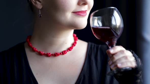 Woman Drink Wine From Glass at Dark Background