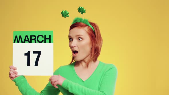 Woman holding calendar with a date for Saint Patrick's Day