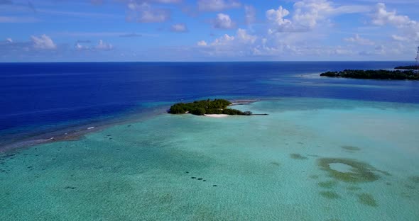 Wide fly over abstract shot of a paradise sunny white sand beach and aqua blue water background in h