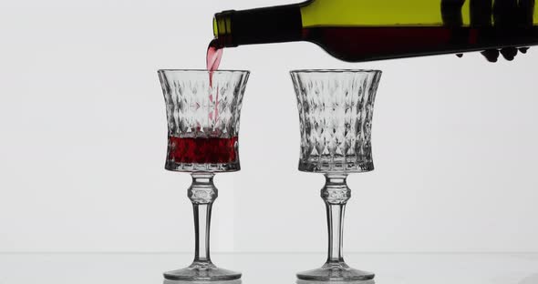 Rose Wine. Red Wine Pour in Two Wine Glasses Over White Background