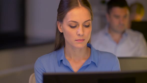 Businesswoman at Computer Working at Night Office 