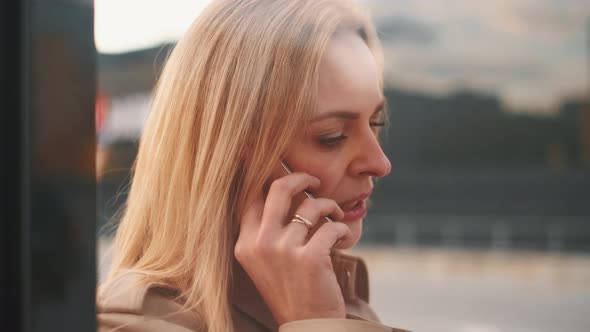 Young Charming Woman Is Calling with Mobile Phone