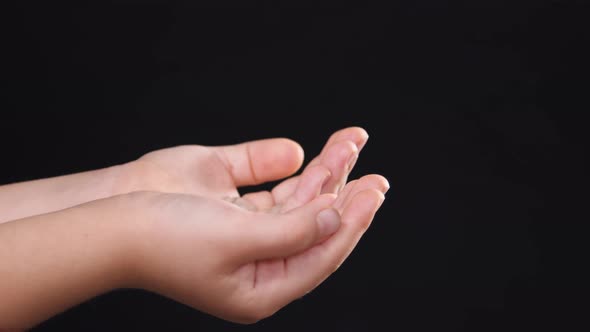 Sanitize children hands with disinfectant gel