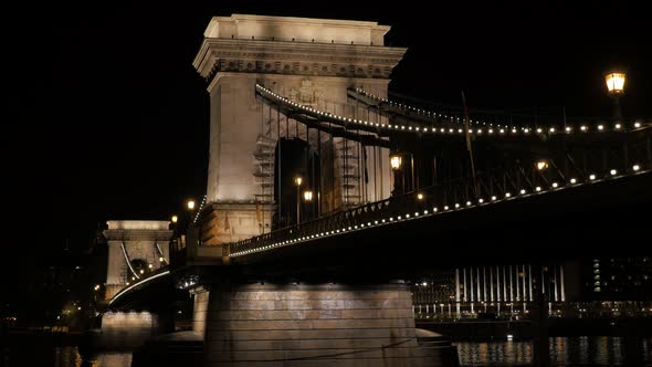 Slow pan on Szechenyi Chain Bridge  over river Danube Budapest by night 4K 2160p UltraHD footage -  