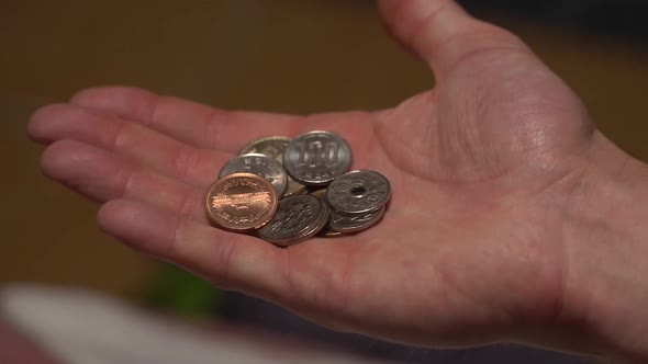 Slow-motion and a close-up shot of Japanese coins and money being thrown and moved between the hands