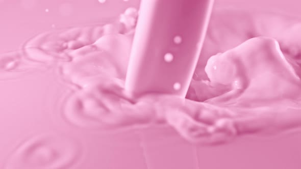Super Slow Motion Shot of Pouring and Splashing Strawberry Milk at 1000Fps
