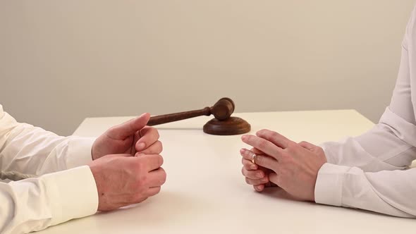 A Woman and a Man Swear and Take Off Their Wedding Rings