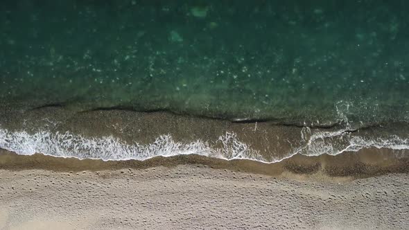 Aerial View From Above on Calm Azure Sea and Volcanic Rocky Shores