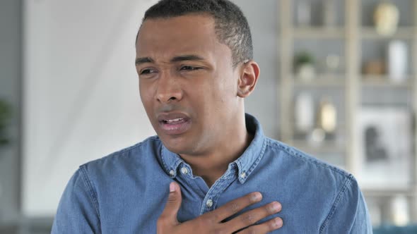 Cough Portrait of Sick Young African Man Coughing at Work