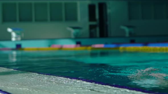 Handsome Young Girl Emerges From Under Water in the Swimming Pool.