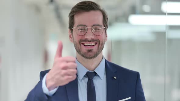 Positive Young Businessman Doing Thumbs Up