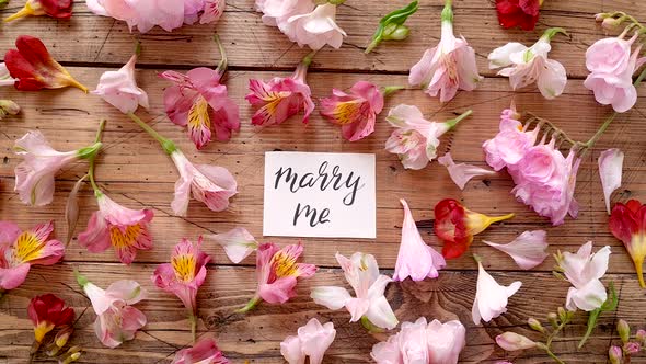 MARRY ME card on a wooden table top view