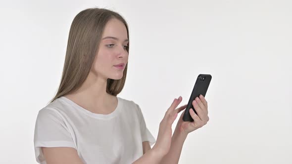 Beautiful Young Woman Facing Loss on Smartphone, White Background