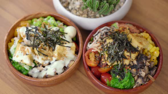 Closeup Shot of Two Poke Bowls on a Wooden Table