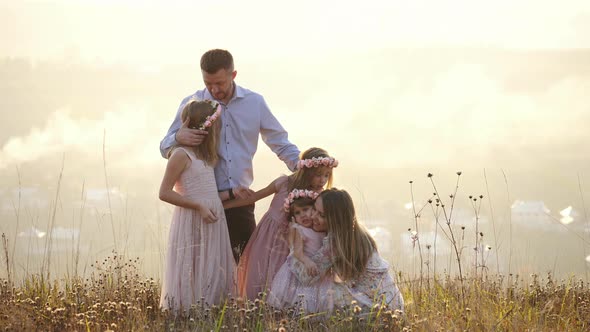 Family of five kissing each other