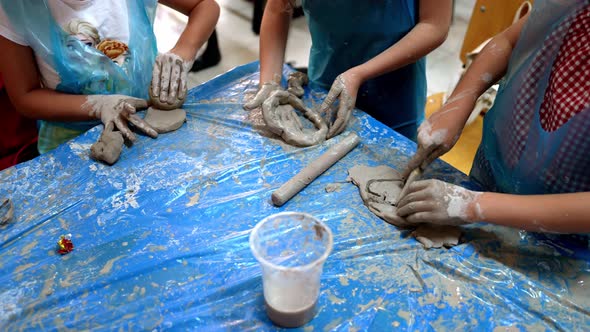 Children Make Shapes From Ceramic Mud