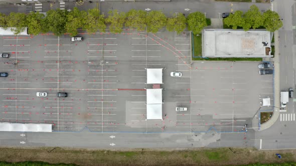 Top View of Cars And Tents At Coronavirus Drive-Thru Testing And Vaccination Site. aerial