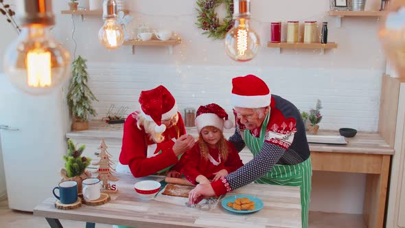 Grandparents with Grandchild Preparing Cooking Homemade Cookie Roll Out Dough Christmas Kitchen