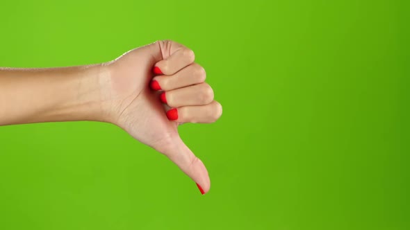 Thumbs Down Female Hand on Green Screen Background. Sign Language