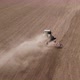 Aerial View of Tractor Cutting Furrows in Farm Field for Sowing Farm Tractor with Rotary Harrow Plow - VideoHive Item for Sale