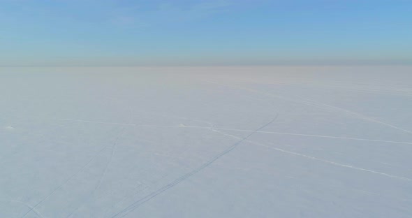 Aerial View of Cold Winter Landscape Arctic Field Trees Covered with Frost Snow Ice River and Sun