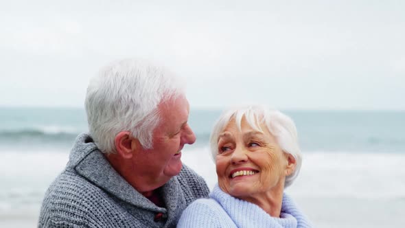 Senior couple embracing each other on the beach