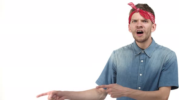 Amazed Handsome Hipster Guy with Red Bandana Wrapped Around Forehead Showing Something Awesome