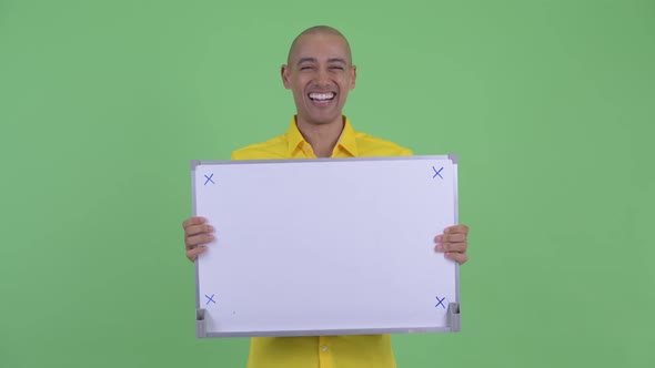Happy Handsome Bald Businessman Talking While Holding White Board
