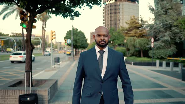 Indian Businessman Wearing Blue Suit Walking Near Office or Hotel