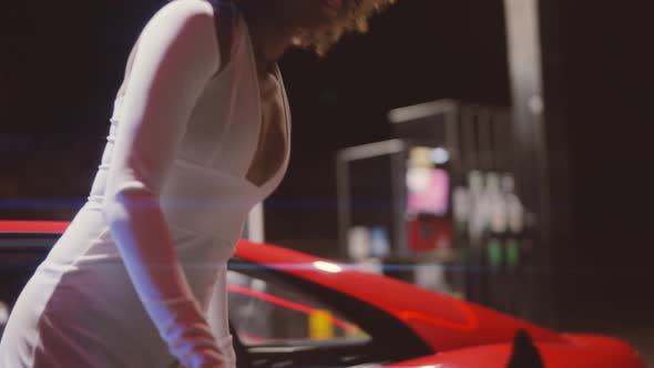 Woman With Afro Getting Out Of Red Ferrari 348 TB At Night