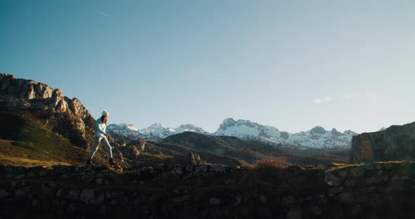 Young Adult Female Traveler Walk on Bridge with Epic Mountain View at Vacations