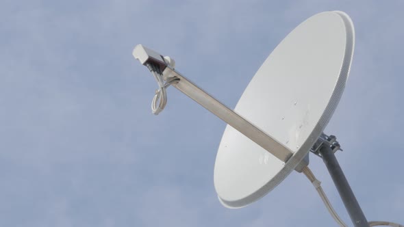 Parabolic satelite dish antenna against blue sky 4K 2160p UltraHD footage - Satellite signal recepti