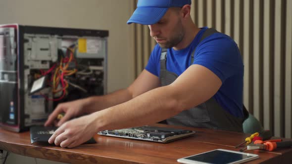 Worker in Uniform Opens Cover of Tablet and Explores Details