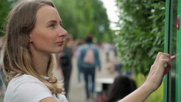 Smiling Female Standing at Big Display with Advanced Digital Technology. Young Woman Touching with