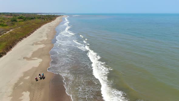 Family Riding Horses on the Seashore