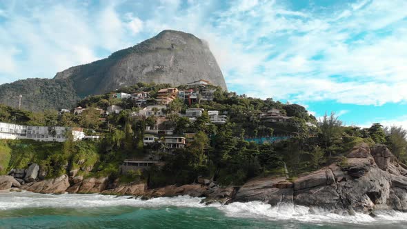 Aerial distancing of the beautiful picturesque cliff rocks of Joatinga beach in Rio de Janeiro with