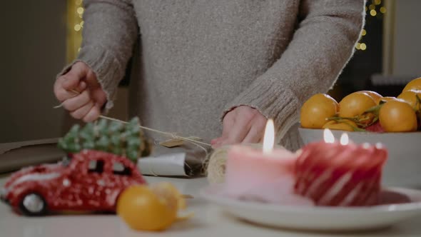 Woman hands make organic packaging Christmas or New year gift