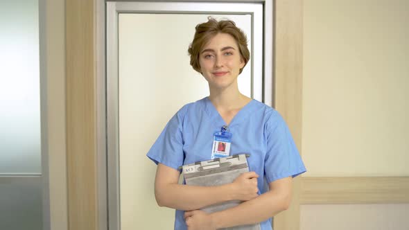Cheerful young beautiful caucasian female professional medical nurse smiling to camera in good mood