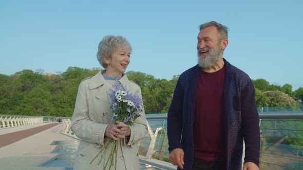 Portrait of Elderly Couple Walking and Talking While Dating Outdoors