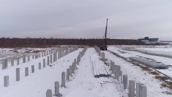 Aerial drone view of many reinforced concrete piles driven into the ground 12